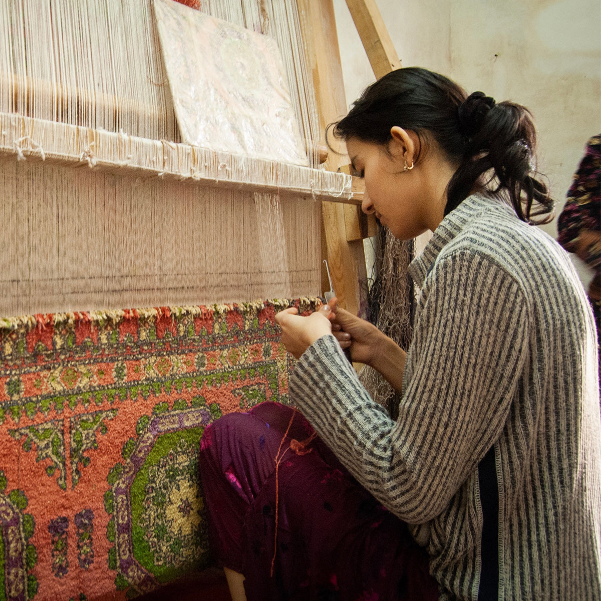 Maya making a hand loomed rug in india for a special maximalist loving customer